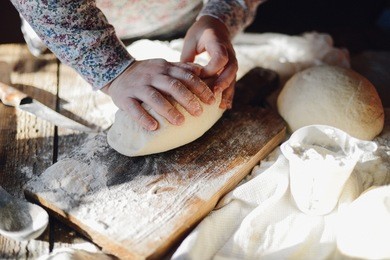 close up view of baker kneading dough. homemade bread. hands preparing bread dough on wooden table. preparing traditional homemade bread. woman hands kneading fresh dough for making bread