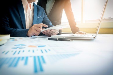 business adviser analyzing financial figures denoting the progress in the work of the company.