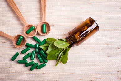 medicine herb. herbal pills with healthy medical plant. green leaf, alternative drug. natural pharmaceutical capsule. vitamin supplement for care, medication, treatment.