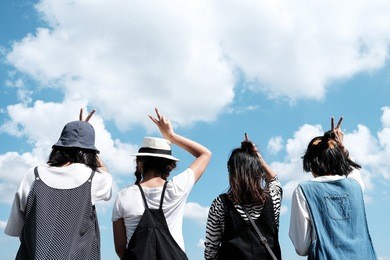 a group of young teenager friends with blue sky background