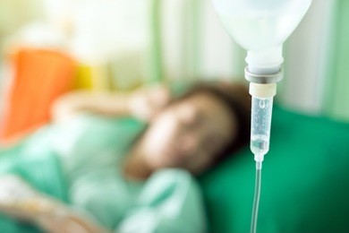 close up of a woman patient in hospital with saline intravenous.