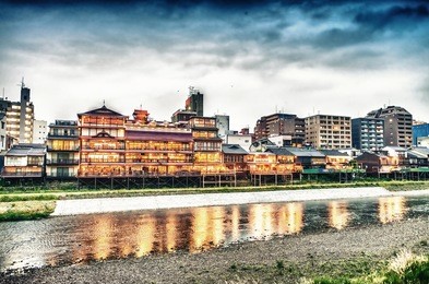 kyoto, japan. sunset view of cityscape along river.