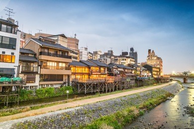 kyoto, japan. sunset view of cityscape along river.