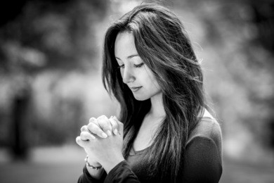 beautiful young woman hands praying in outdoors