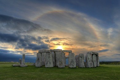 high dynamic range (hdr) image of stonehenge  at sunset with beautiful solar sunset halo - an optical phenomenon that appears  around the sun caused by ice crystals  in the upper troposphere.