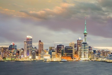 auckland, new zealand's largest city, under a dramatic twilight sky.