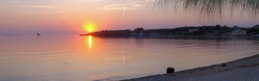 sunset on sea (bay and cape in the distance)