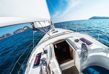 sailing vessel moves in an open sea under the sails