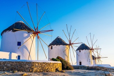 famous mykonos town windmills in a romantic sunset, mykonos island, cyclades, greece