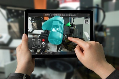 industrial 4.0 , augmented reality concept. hand holding tablet with ar service , maintenance application and calling technician for check destroy part of smart machine motor in smart factory