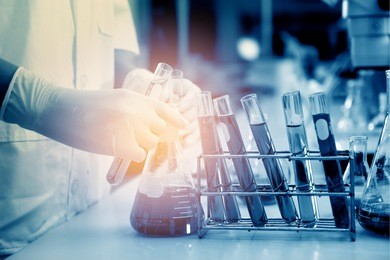 scientist hand holding laboratory test tube with soft focus