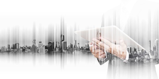 businessman working on digital tablet with double exposure city background, business technology network concepts