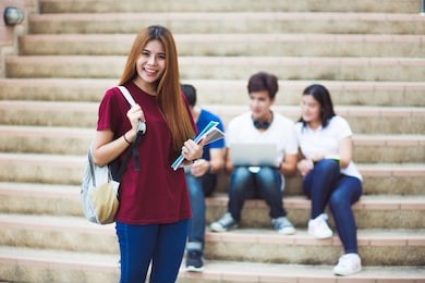 group of happy teen high school students outdoors