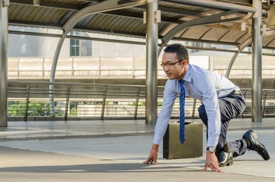 young smart determined asian businessman standing in start position runner, business competition concept.