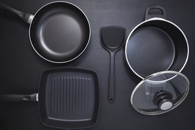 top view frying pan and pot on black table