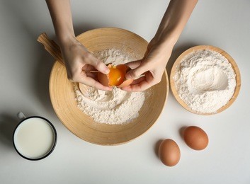 woman making dough on kitchen table