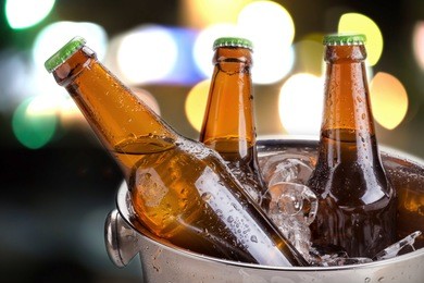 cold bottles of beer in bucket with ice in a restaurant setting