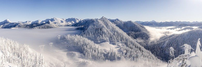 cascade mountain range panorama with ice cold winter snow and hazy blue sky