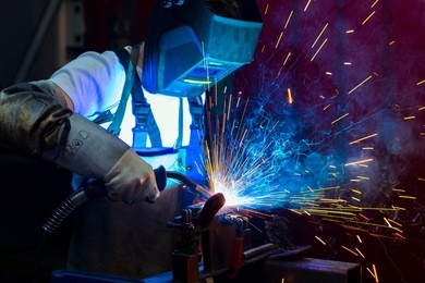 man welding metal in the factory