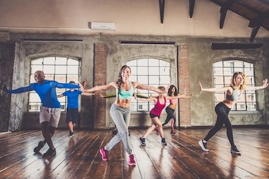 group of sportive people training in a gym - multi-ethnic group of athletes doing fitness