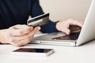 male hands holding credit card and using laptop. online shopping concept