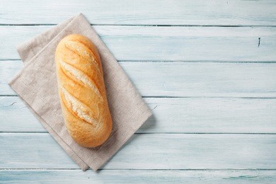 fresh bread on wooden table. top view with space for your text