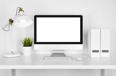 blank screen computer, lamp and table folder over white background