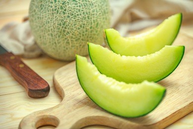 fresh sweet green melon on the wooden table