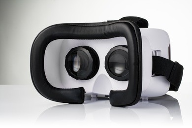 virtual reality vr glasses or goggles isolated on white background with mirror reflection. closeup product photograph. computer simulated reality concept image with copy space