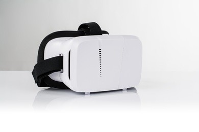virtual reality vr glasses or goggles isolated on white background with mirror reflection. closeup product photograph. computer simulated reality concept image with copy space