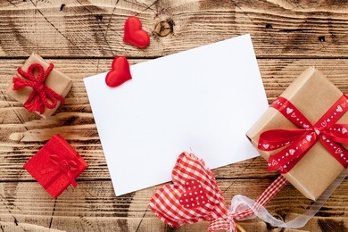 valentine day wood background with gifts and hearts, top view