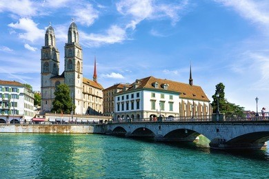limmat river quay with grossmunster church in zurich. switzerland
