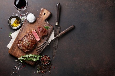 grilled ribeye beef steak with red wine, herbs and spices. top view with copy space for your text