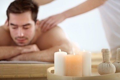 burning candles and young man on background