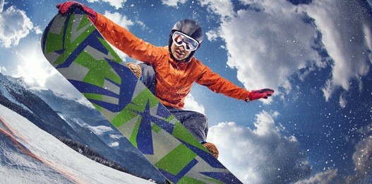 sport background. winter sport. snowboarder jumping through air with deep blue sky in background.