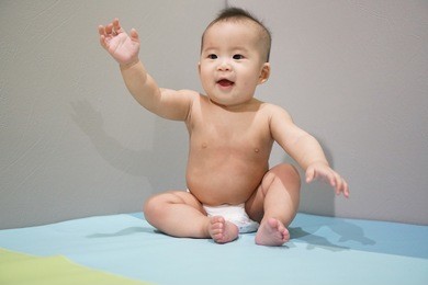 infant girl portrait, happy baby learn to craw around and stand and wear diaper