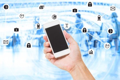 hand holding mobile phone over double exposure of blurred people travel and data management system internet of things graphics design