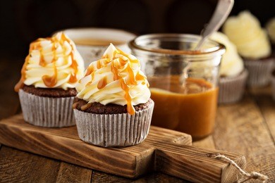 homemade butterscotch cupcakes with caramel syrup and cream cheese frosting