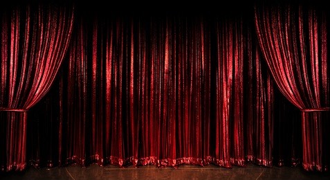 stage red curtains over wooden floor