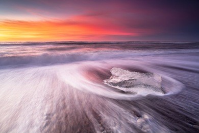 ice on the beach near jokulsarlon glacier lagoon, winter iceland. jokulsarlon beach at sunrise. pink sunrise with ice.
