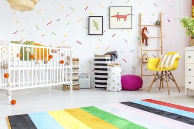 baby room with yellow chair and white cot