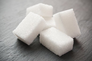 closeup of sugar cube on chalkboard background
