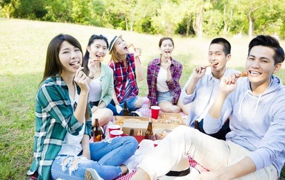 happy young friends enjoying  healthy picnic