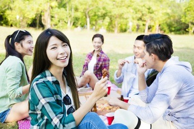 happy young friends enjoying  healthy picnic