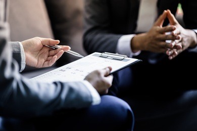 business partners discussing documents and ideas at meeting