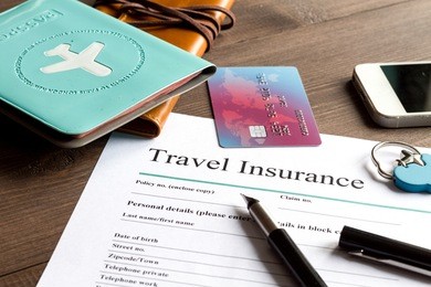 concept booking travel insurance on wooden background