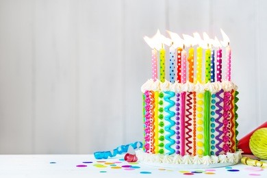 rainbow cake with colorful candles
