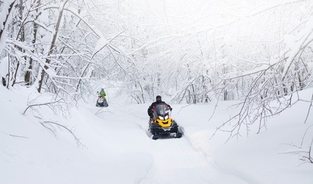 winter snowy lanscape with road and snowmobile