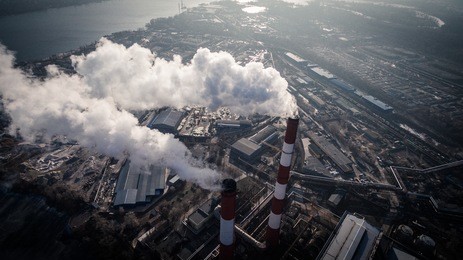 air pollution by smoke coming out of two factory chimneys. industrial zone in the city. kiev, ukraine, aerial view