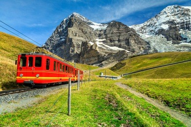 famous electric retro red tourist train coming down from the jungfraujoch station(top of europe) in kleine scheidegg, bernese oberland, switzerland, europe